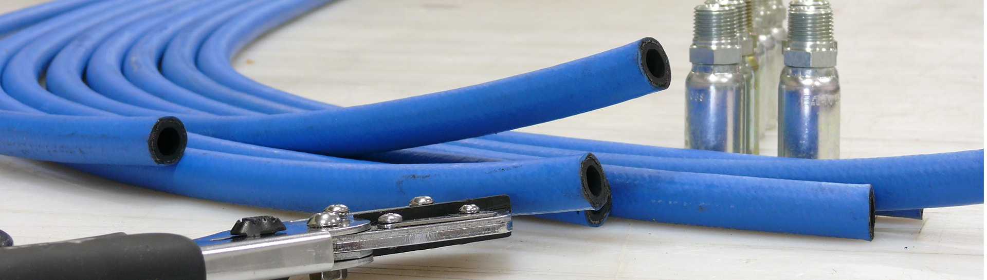 This is an image of rubber hose, fittings, and a tool.